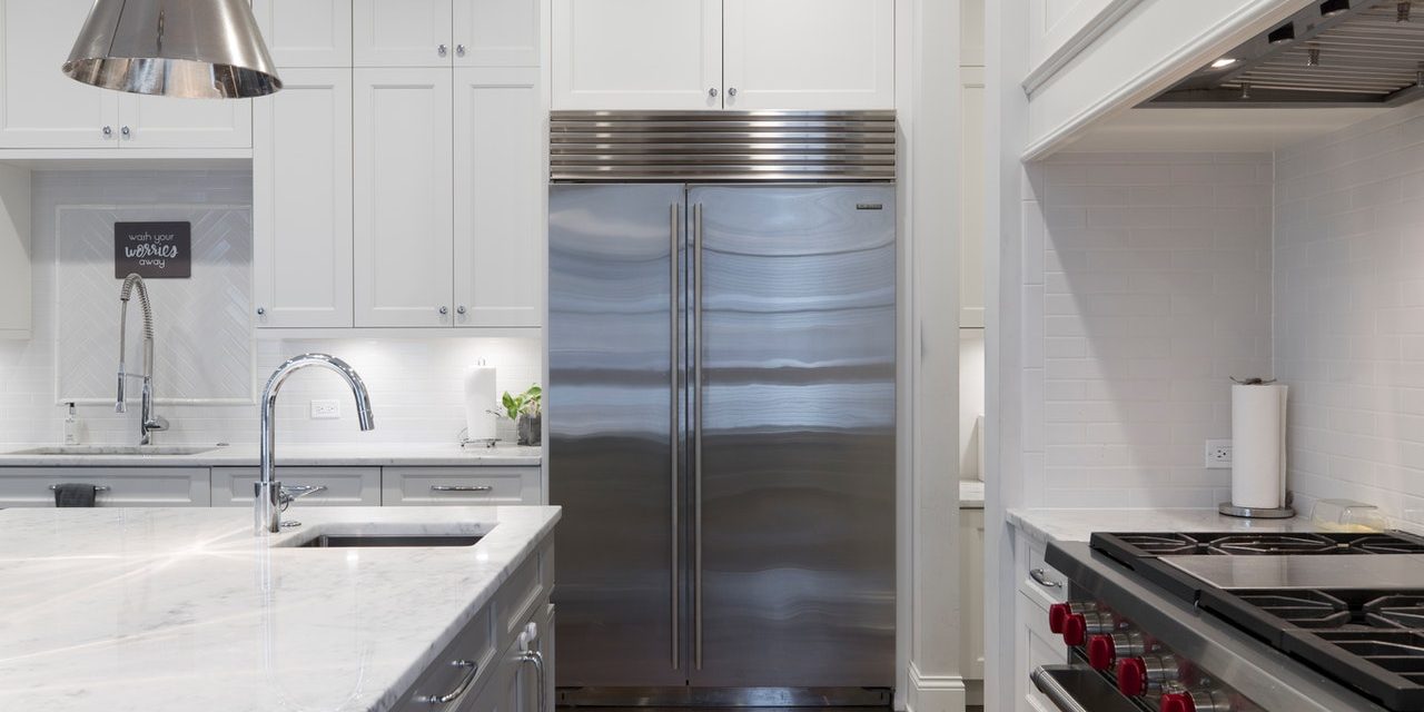 stainless-steel-refrigerator-beside-white-kitchen-cabinet-2343467